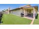A lovely home showcasing a backyard with artificial grass and a covered patio for outdoor enjoyment at 7253 S Terrace Rd, Tempe, AZ 85283