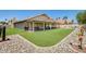 A home's backyard featuring artificial grass and a covered patio, perfect for outdoor living at 7253 S Terrace Rd, Tempe, AZ 85283