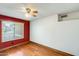 Cozy bedroom with wood floors, a ceiling fan, and a bright window at 7253 S Terrace Rd, Tempe, AZ 85283