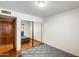 Bedroom featuring hardwood floors, closet with mirror doors, and a bed at 7253 S Terrace Rd, Tempe, AZ 85283