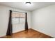 Neutral bedroom featuring hardwood flooring, with a window providing natural light, and minimalist decor at 7253 S Terrace Rd, Tempe, AZ 85283