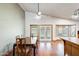 Vaulted dining room showcasing wood floors, bright windows, and a modern ceiling fan at 7253 S Terrace Rd, Tempe, AZ 85283