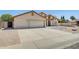 Well-maintained home with a spacious driveway, two-car garage, and landscaped front yard at 7253 S Terrace Rd, Tempe, AZ 85283