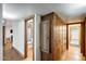 Hallway with hardwood flooring, connecting the rooms, and built-in wooden storage cabinets at 7253 S Terrace Rd, Tempe, AZ 85283