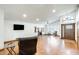Bright living room with hardwood floors, fireplace, front door, and large wall mounted television at 7253 S Terrace Rd, Tempe, AZ 85283