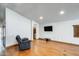 Living room with hardwood floors, wall mounted TV and an accent fireplace at 7253 S Terrace Rd, Tempe, AZ 85283
