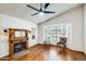 Bright living room featuring hardwood floors, a cozy fireplace, and a large bay window for natural light at 7253 S Terrace Rd, Tempe, AZ 85283