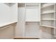 Bright walk-in closet with white shelving and hardwood floors, perfect for organization and storage at 7253 S Terrace Rd, Tempe, AZ 85283