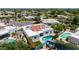 Aerial view of white single-Gathering home with red tile roof, backyard swimming pool, and lush landscaping at 7328 E Laredo Ln, Scottsdale, AZ 85250