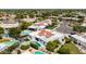Aerial view of white single-Gathering homes with red tile roofs, backyard swimming pools, and lush landscaping at 7328 E Laredo Ln, Scottsdale, AZ 85250
