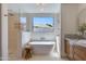 Spa-like bathroom featuring a soaking tub, walk-in shower, and a modern vanity for a relaxing experience at 7328 E Laredo Ln, Scottsdale, AZ 85250