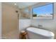 Bright bathroom features a soaking tub, walk-in shower, and modern fixtures for a spa-like experience at 7328 E Laredo Ln, Scottsdale, AZ 85250