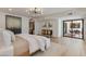 Bright bedroom featuring a modern chandelier, stylish furnishings, and sliding glass doors to outdoor seating at 7328 E Laredo Ln, Scottsdale, AZ 85250
