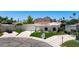 An aerial view of a white single-Gathering home with a red tile roof, green grass, and well manicured landscaping at 7328 E Laredo Ln, Scottsdale, AZ 85250