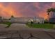 Modern white home featuring red tile roof and lush green lawn at sunset at 7328 E Laredo Ln, Scottsdale, AZ 85250