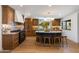 Modern kitchen featuring wood cabinets, geometric backsplash, black appliances, and island with barstools at 7328 E Laredo Ln, Scottsdale, AZ 85250