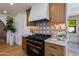 Modern kitchen featuring black appliances, white countertops, and wood cabinets at 7328 E Laredo Ln, Scottsdale, AZ 85250