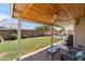 This is a backyard featuring a covered patio, a pool, and well-maintained grass at 7649 W Dahlia Dr, Peoria, AZ 85381