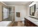 Bathroom featuring a modern vanity, a framed shower with glass doors, and a soaking tub at 7649 W Dahlia Dr, Peoria, AZ 85381