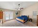 This is a primary bedroom with outdoor access and neutral coloring at 7649 W Dahlia Dr, Peoria, AZ 85381