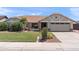 Charming single-story home featuring manicured landscaping, warm exterior lighting, and a welcoming two-car garage at 7649 W Dahlia Dr, Peoria, AZ 85381
