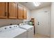 Functional laundry room equipped with modern appliances and ample storage cabinets at 7649 W Dahlia Dr, Peoria, AZ 85381