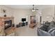 Spacious living room with vaulted ceilings, cozy fireplace, and tile flooring at 7649 W Dahlia Dr, Peoria, AZ 85381