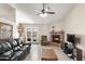 Cozy living room featuring a brick fireplace, wet bar, tile floor, and a comfortable seating arrangement at 7649 W Dahlia Dr, Peoria, AZ 85381
