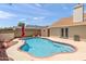 Backyard featuring a sparkling pool surrounded by a brick border, desert landscaping, and privacy fence at 7649 W Dahlia Dr, Peoria, AZ 85381