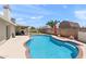 This is a fenced-in outdoor pool area with grass, a patio, and lounge seating at 7649 W Dahlia Dr, Peoria, AZ 85381