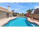 Inviting backyard featuring a sparkling pool, patio, and lush landscaping for relaxation and outdoor enjoyment at 7649 W Dahlia Dr, Peoria, AZ 85381
