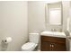 Powder room featuring a wood cabinet, brushed nickel faucet, and ample lighting at 8036 E Mercer Ln, Scottsdale, AZ 85260