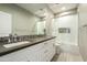 Beautiful bathroom with double sinks, large mirror, and a tub shower with glass doors at 8036 E Mercer Ln, Scottsdale, AZ 85260