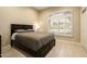Well-lit bedroom features a decorative window, neutral color palette, and sleek tiled flooring at 8036 E Mercer Ln, Scottsdale, AZ 85260