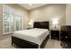 Bedroom featuring tiled flooring, window with shutters, and neutral-toned walls at 8036 E Mercer Ln, Scottsdale, AZ 85260