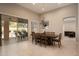 Elegant dining area with a dark wood table, seating for eight, and view of the outdoor patio at 8036 E Mercer Ln, Scottsdale, AZ 85260