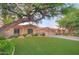 Charming single-story home featuring mature shade trees, lush lawns, and a three-car garage at 8036 E Mercer Ln, Scottsdale, AZ 85260
