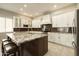 The kitchen boasts white cabinets, stainless steel appliances, and a large center island with seating at 8036 E Mercer Ln, Scottsdale, AZ 85260