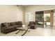 Cozy living room with a comfortable sofa, stylish chairs, a glass table, and sliding glass door to the patio at 8036 E Mercer Ln, Scottsdale, AZ 85260