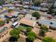 Aerial view showcasing home, large lot, backyard with covered patio and storage shed at 8132 W Pierson St, Phoenix, AZ 85033