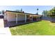 Spacious backyard features a large covered patio and lush green lawn at 8132 W Pierson St, Phoenix, AZ 85033