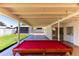 Backyard patio featuring a pool table, view of the yard and utility area at 8132 W Pierson St, Phoenix, AZ 85033
