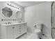 Bright bathroom with double vanity, framed mirrors and shower with glass door at 8132 W Pierson St, Phoenix, AZ 85033