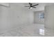 Spacious bedroom with large window, ceiling fan and bright tile flooring at 8132 W Pierson St, Phoenix, AZ 85033