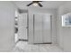 Bedroom with window and closet featuring stylish tile flooring at 8132 W Pierson St, Phoenix, AZ 85033