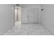 Clean, bright bedroom offers large closet, an open door and modern tile flooring at 8132 W Pierson St, Phoenix, AZ 85033