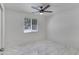 Bright bedroom features modern ceiling fan, bright window and sleek, stylish tile flooring at 8132 W Pierson St, Phoenix, AZ 85033