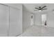 Bedroom with a ceiling fan, closet and views into the adjoining rooms at 8132 W Pierson St, Phoenix, AZ 85033