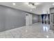 Spacious living area featuring contemporary lighting, smooth gray walls and eye-catching tile floors at 8132 W Pierson St, Phoenix, AZ 85033
