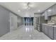 Open-concept living area boasts sleek gray walls, stainless steel appliances and modern tiled floors at 8132 W Pierson St, Phoenix, AZ 85033